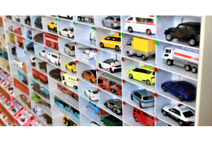 A large collection of organized toy cars. They are displayed in a cubby storage and labeled by numbers.