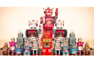 An array of toy robots of various shapes, sizes, colors, and designs, arranged in a pyramid shape by height.